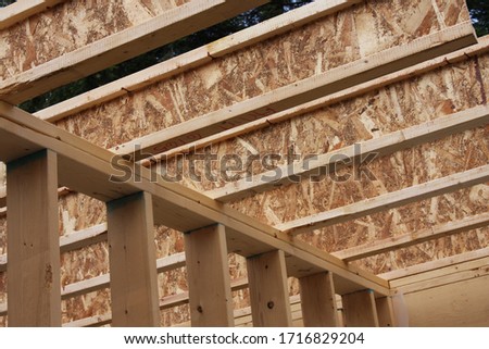 Laminated joists resting on stud wall. Royalty-Free Stock Photo #1716829204