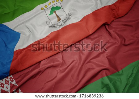 waving colorful flag of belarus and national flag of equatorial guinea. macro
