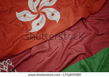 waving colorful flag of belarus and national flag of hong kong. macro