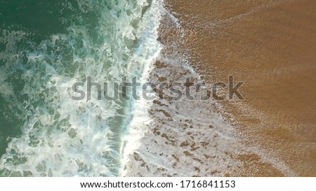 Sea white foam on the crest of a wave. Bubbling water. A wave running ashore.
Pacific Ocean. Photo taken from a drone.