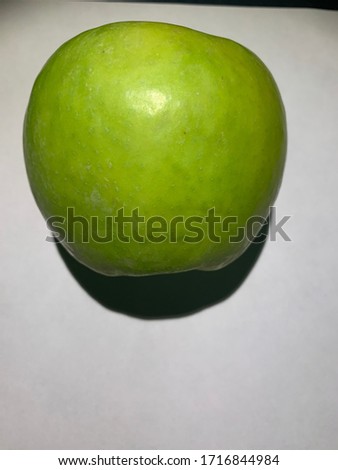 Green,beautiful,delicious apple. Photographed just wonderful,bright pronounced color of the apple.