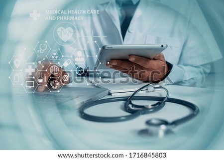 Double exposure of healthcare And Medicine concept. Doctor holding tablet  and modern virtual screen interface icons.