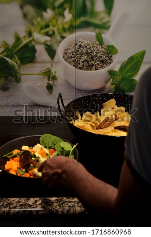 Chef cooking sauteed vegetables at home