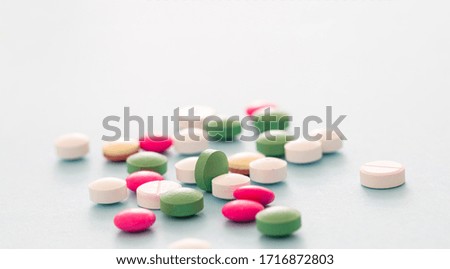 Medicine pills on blue pastel background. Colorful variation of pharmacy products, closeup view. Medical treatment, health concept