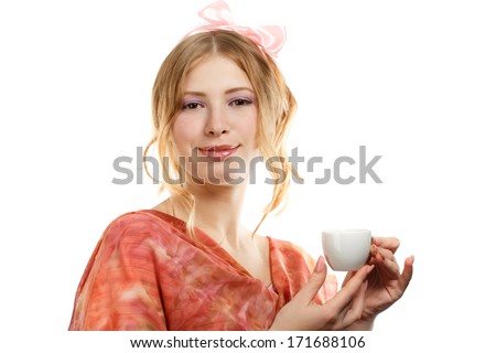 Beautiful young woman with expressive hairstyle and pink bow holding white coffee cup isolated on white background
