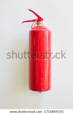fire extinguisher on a white wall background. fire concept