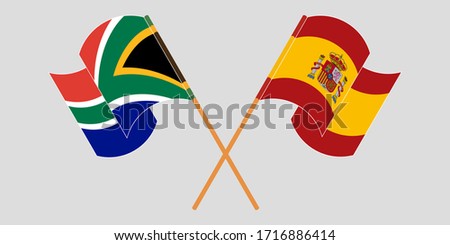 Crossed and waving flags of South Africa and Spain
