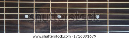 Guitar fretboard. Banner. Close-up. Vulture of an acoustic guitar.  Royalty-Free Stock Photo #1716891679