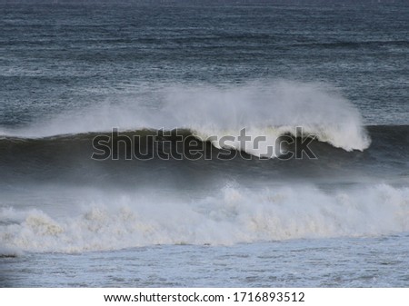 A large wave breaks at a beach in Wellfleet, Cape Cod.