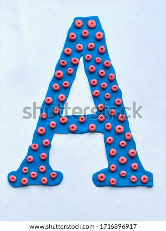The letter A is blue with red spots, made of plasticine, handmade.