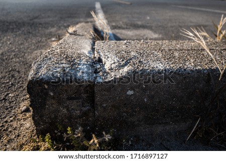 Damaged border stone on parking lot