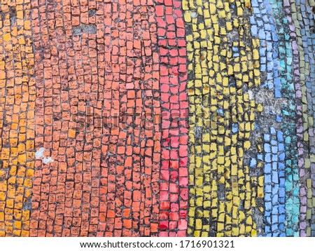 Mosaic wall decoration with rainbow elements. Urban architecture, decorative ornaments.