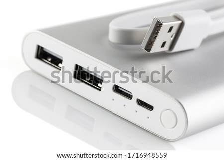 An additional stand-alone power bank for charging mobile devices. External battery isolated on a white background. White charger for smartphone with power supply (battery bank) . Selective focus.