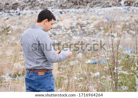 garbage recycling concept. man on dumpster background. Keeping the environment clean. Ecological
