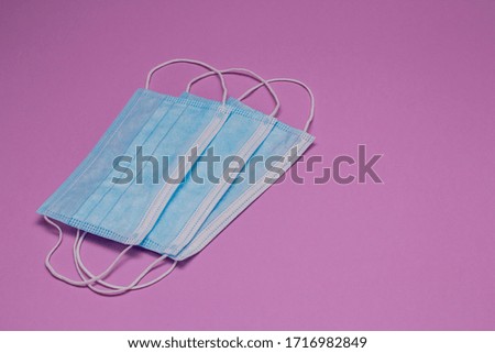 blue medical masks, on a background of natural colored textured paper. protection from cough