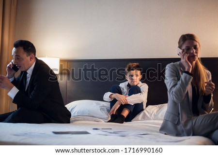 business, technology, internet and hotel concept - business people in the hotel room with their little son