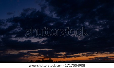 Blackout. Purple-magenta clouds. Tragic gloomy sky. Landscape with bloody sunset. Fantastic skies on the planet earth. Twilight, nightfall. Royalty-Free Stock Photo #1717004908