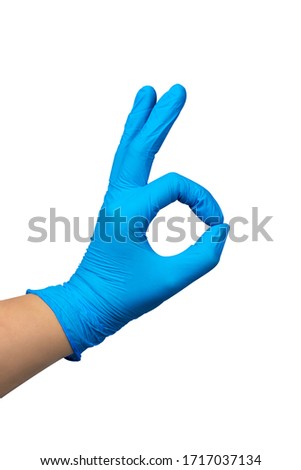 Female hand in blue surgery rubber gloves making OK sign isolated on a white background. Clipping path included.