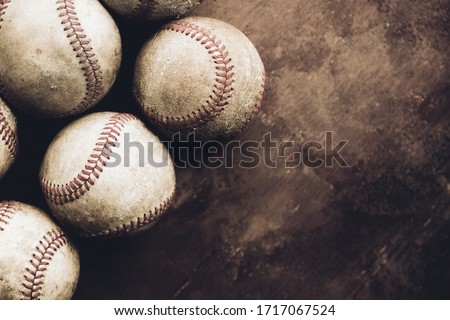 Rough and rugged texture of old baseball balls close up on brown vintage background, copy space for sport.