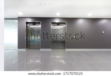 Two lifts or elevators in a building lobby. Royalty-Free Stock Photo #1717070125