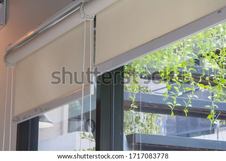 Close-up of roller blinds or curtain at the glass window Royalty-Free Stock Photo #1717083778
