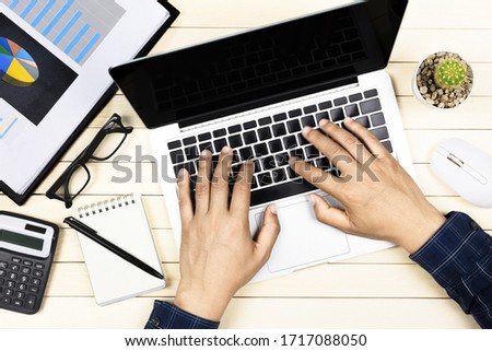 businessman working with modern workplace with laptop on wood table, Man hand on laptop keyboard for work from home, Overhead view of businessman working  in office