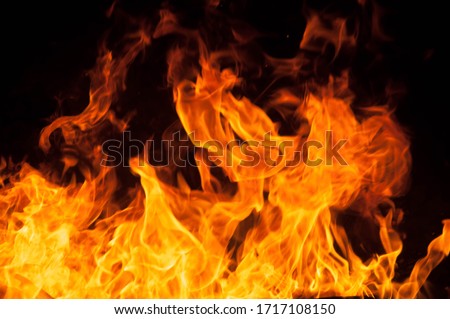 Fire creates infinity shapes when it burns. The orange from the flame and the black backgroud creates interesting textures. Flames from hell. Burning power. Royalty-Free Stock Photo #1717108150