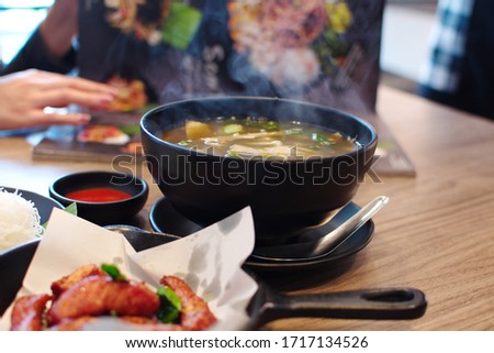 Hot soup with smoke on the table, healthy eating, eat hot and use medium spoon for meal protection of personal from Corona or Covid 19 