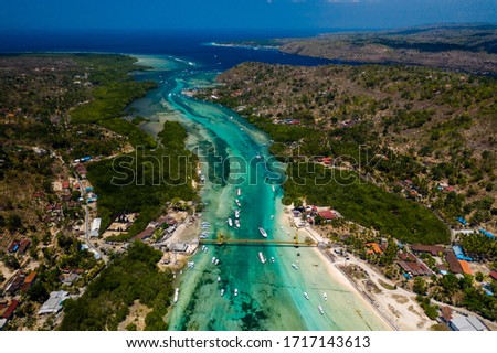 Aerial view of a bridge connecting two tropical islands over a narrow ocean channel (Nusa Lembongan and Nusa Ceningan, Indonesia)