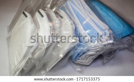 Set of surgical and FFP2 masks packaged in transparent plastic bags. Disposable face mask protective against coronavirus, Covid-19, pollution, virus, and flu. Health care and surgical concept