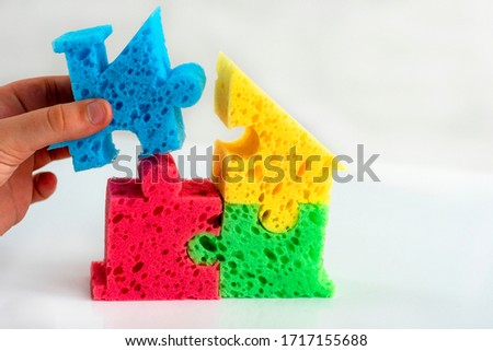 Hand holds part of the house. Creation and design of dwelling. Concept purchase, rent of housing. The symbol of the house. Construction  building. Concept Construction of housing