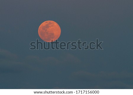 Pink full moon and clouds