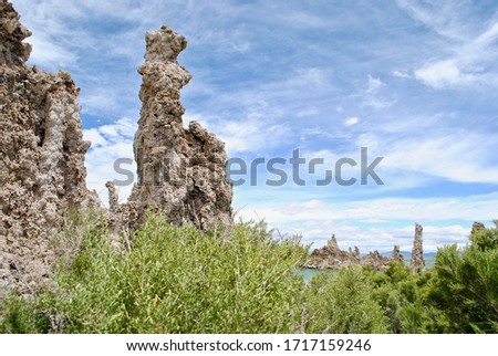 Mono Lake is a saline soda lake in Mono County, California. Many columns of limestone, called tufa, rise above the surface of Mono Lake. The Sierra Nevada Mountain Range is in the background.