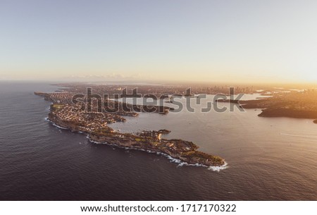 High resolution panoramic sunset aerial drone view of South Head, a headland to the north of Watsons Bay suburb in Sydney, New South Wales, Australia. Harbour and city centre in the background.
