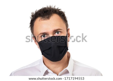 Man in medical mask with tousled hair Isolated on a white background. Concept on the topic of annoying quarantine and the inability to cut your hair Royalty-Free Stock Photo #1717194553