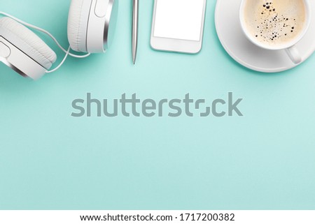 Workplace desk table with smartphone, headphones and coffee. Top view with space for your text or app. Flat lay