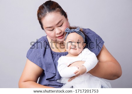 Asian young fashion girl with mother on gray background