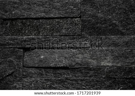 dark wall coverings in the form of natural stone for facing, landscape, interior.