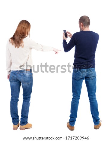 Back view of couple in sweater with mobile phone. Rear view people collection. backside view of person. Isolated over white background.