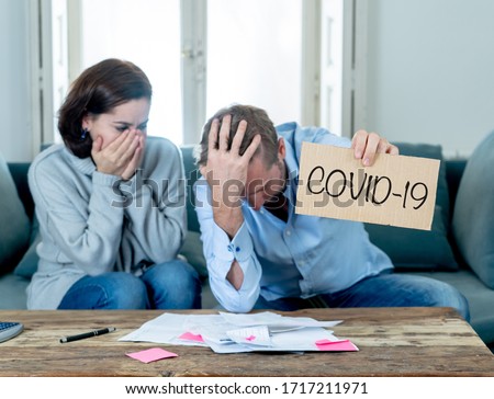 COVID-19 Shutdowns, Economic recession. Stressed couple having financial problems needing help paying bills mortgage rent and expenses due to job loss and business closed amid coronavirus outbreak. Royalty-Free Stock Photo #1717211971