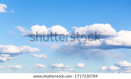 nanural panoramic background - many small cumulus clouds in blue sky on March day Royalty-Free Stock Photo #1717230784