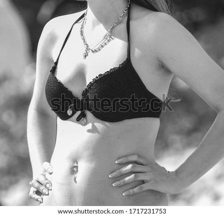 Girl in a swimsuit on the seashore. Rest at the resort.
