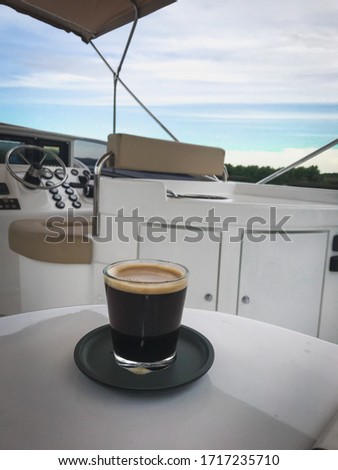 
Glass of espresso coffee on the table of a yacht. Coffee time. Luxury lifestyle.