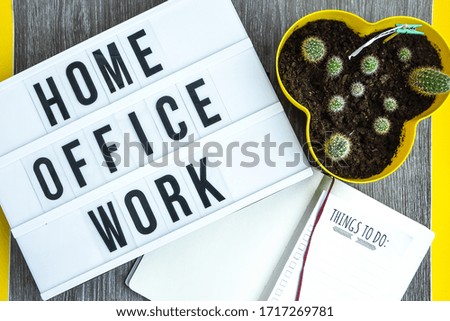 lightbox with text HOME OFFICE WORK with notebook pen and cactus and TO DO list, copy space wooden table background, quarantine and isolation HOME OFFICE, coronavirus, europe