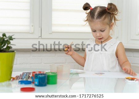 Girl paints in self-isolation quarantine paints, mixes paints and prepare to paint