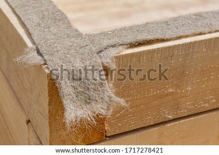 bbuilding a house from timber laying jute Royalty-Free Stock Photo #1717278421