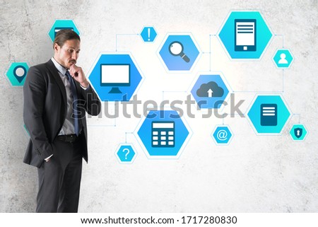 Businessman thinking and drawing cloud computing diagram on wall. Business and technology concept.