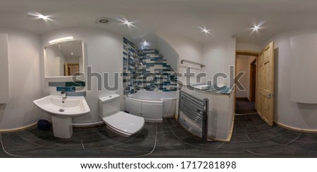 360 Degree full sphere panoramic photo of a modern newly build house interior bathroom showing the toilet, sink and shower and L-shaped bath