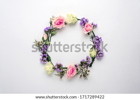 flower circle, frame on white background, composition of pink roses, limonium, eustoma with copy space, flat lay, top view