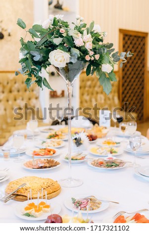 Beautiful wedding decor. Ceremony, floristry and decoration of halls, banquets, wedding arches, rings in a casket, invitation, bright flowers, details and elements of a wedding day.
